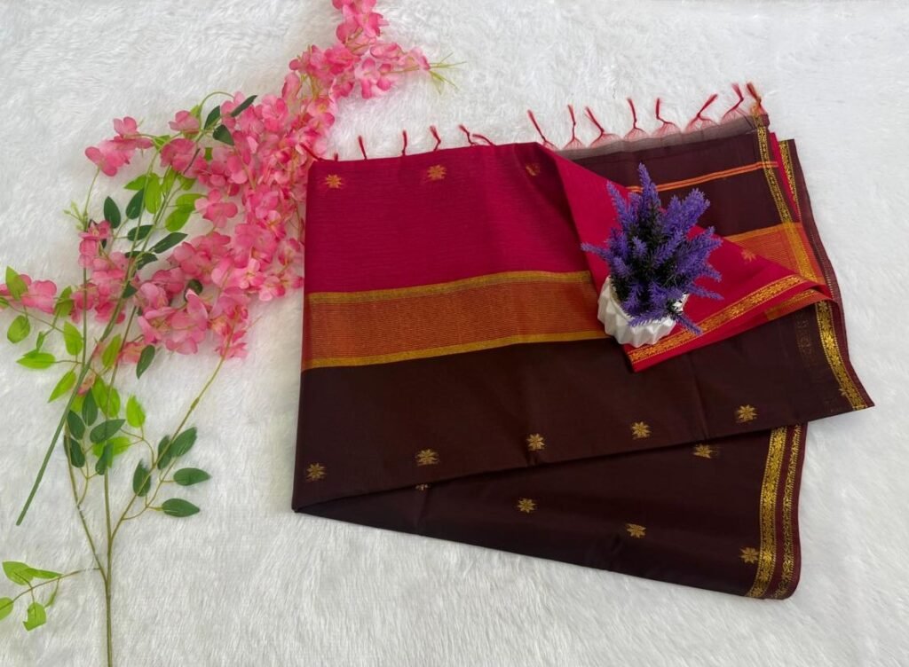 Deep brown saree with gold motifs and a vibrant pink pallu with gold zari border.