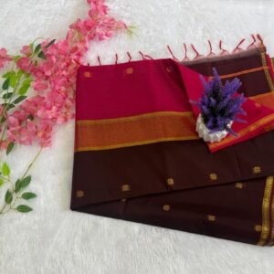 Deep brown saree with gold motifs and a vibrant pink pallu with gold zari border.