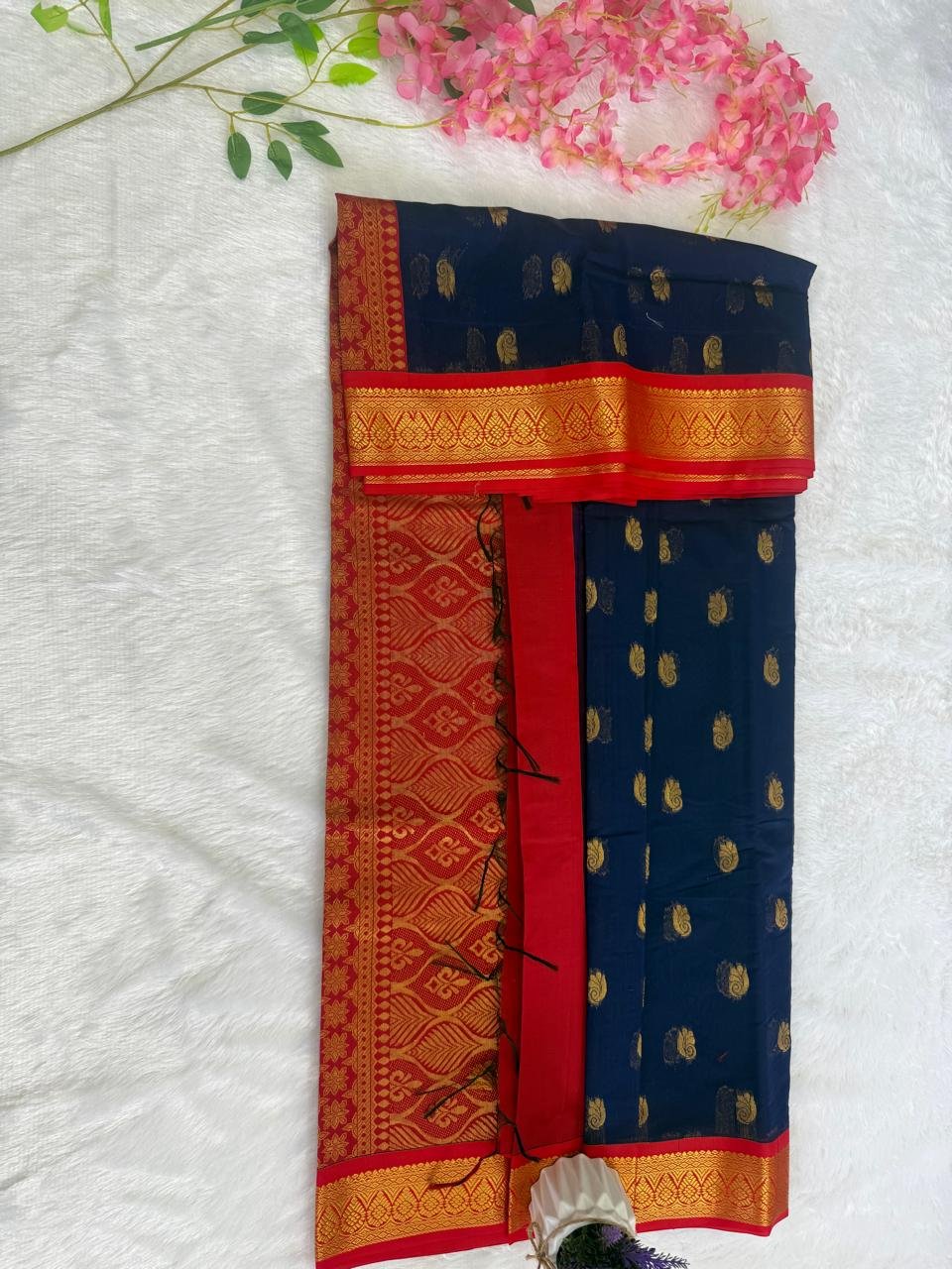 Crimson red saree featuring a fine gold check pattern and a solid gold zari temple border.