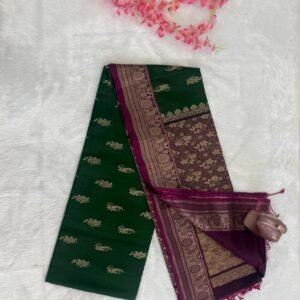 Emerald green saree with gold motifs and a contrasting deep purple pallu with heavy gold brocade floral work.
