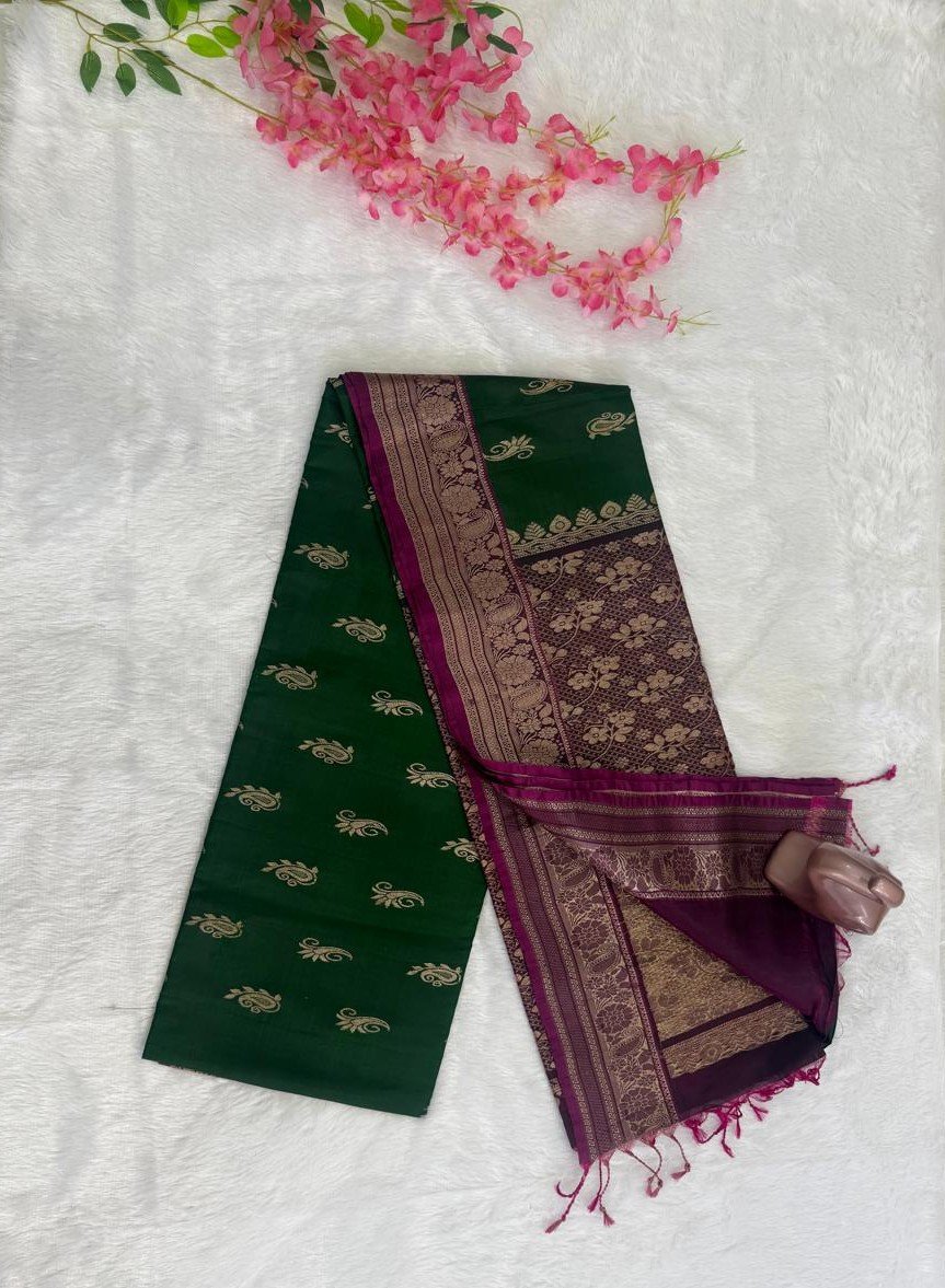 Emerald green saree with gold motifs and a contrasting deep purple pallu with heavy gold brocade floral work.