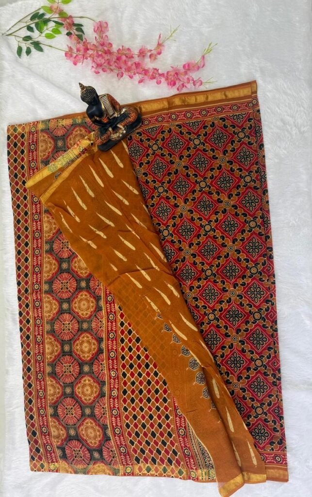 Saree featuring intricate red and black geometric patola prints paired with a mustard yellow section with feather-like motifs and a gold zari border.