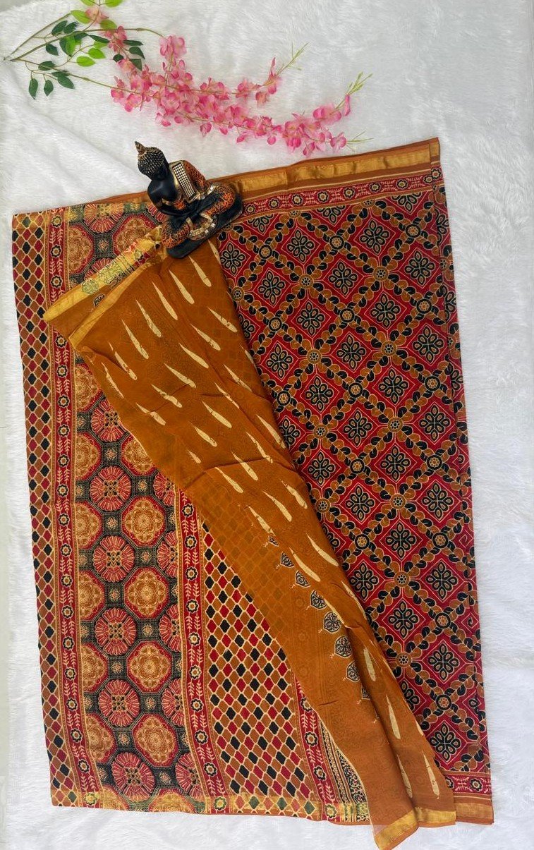 Saree featuring intricate red and black geometric patola prints paired with a mustard yellow section with feather-like motifs and a gold zari border.