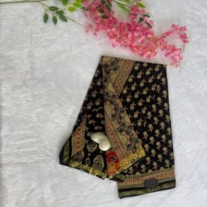 Solid black saree paired with a tussar beige Kalamkari style floral printed border and striped pallu.