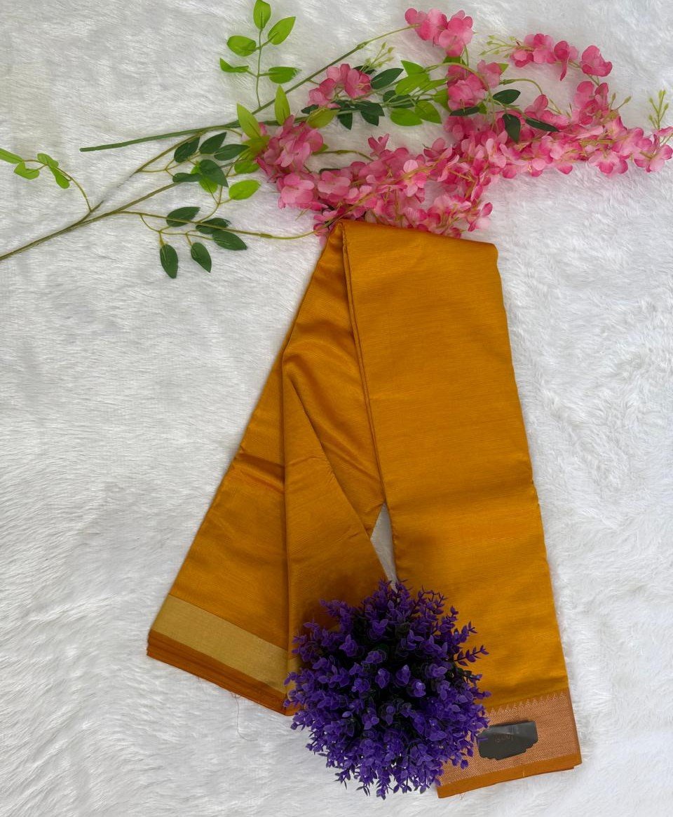 Solid golden mustard yellow saree with a broad gold zari border.